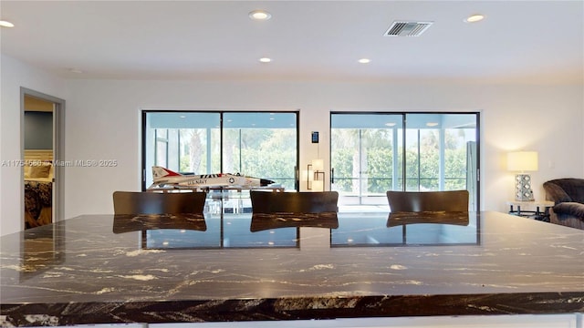 kitchen featuring open floor plan, plenty of natural light, visible vents, and recessed lighting