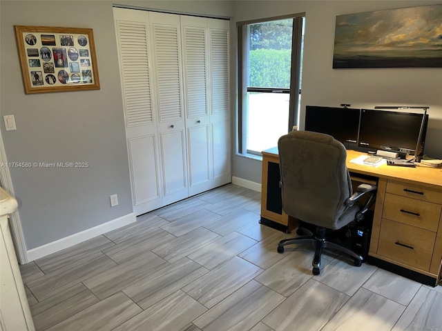 office with wood tiled floor, plenty of natural light, and baseboards