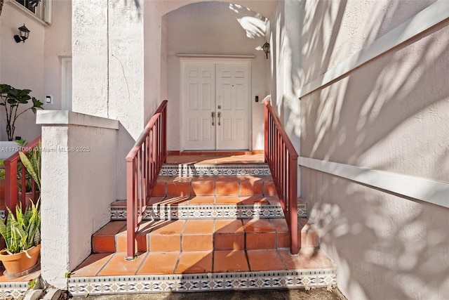 property entrance with stucco siding