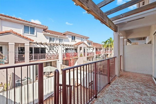 balcony featuring a residential view and a pergola