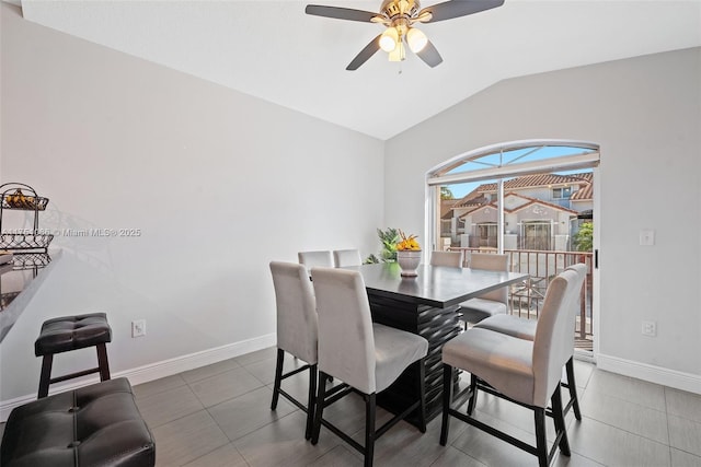 tiled dining space with baseboards, lofted ceiling, and ceiling fan