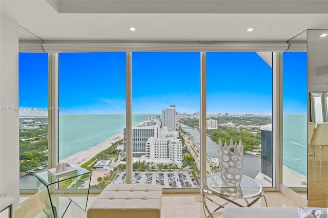 unfurnished sunroom featuring a city view and a water view