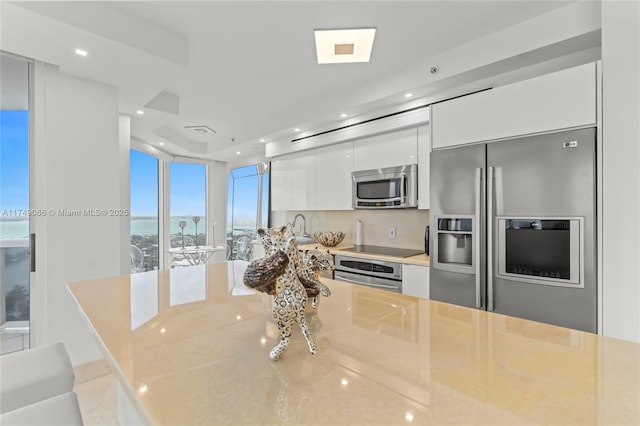 kitchen featuring appliances with stainless steel finishes, modern cabinets, recessed lighting, and white cabinets