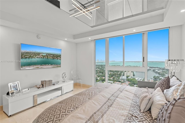 bedroom with recessed lighting and a water view