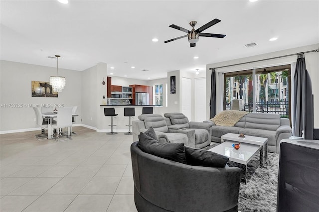 living room with recessed lighting, plenty of natural light, baseboards, and light tile patterned floors