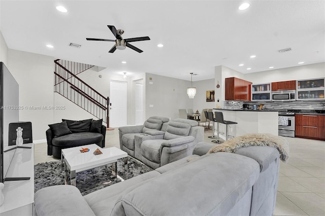 living area with stairs, light tile patterned floors, visible vents, and recessed lighting