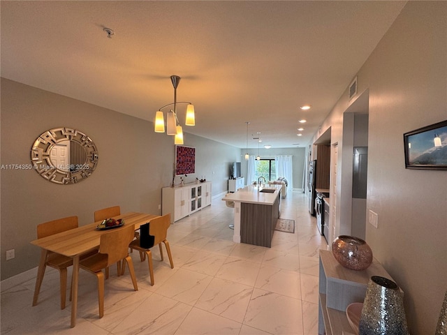 dining space featuring recessed lighting, marble finish floor, and baseboards