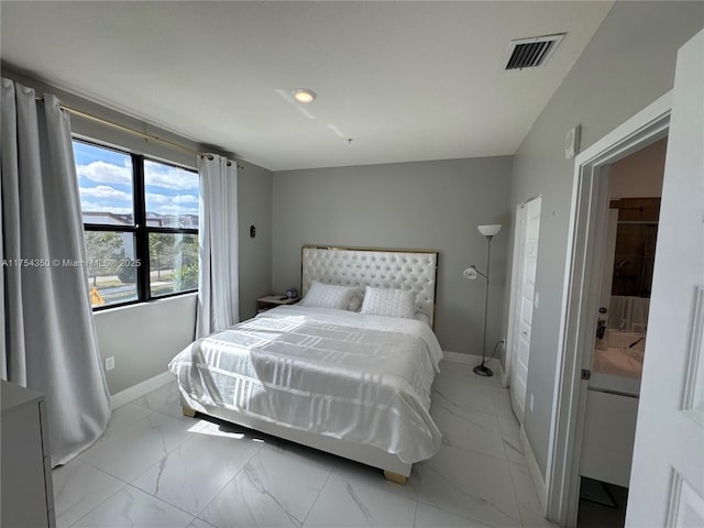 bedroom with marble finish floor, visible vents, and baseboards