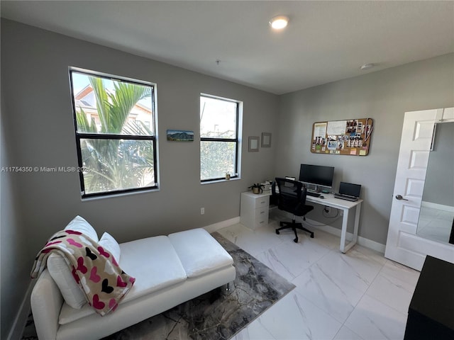 bedroom featuring marble finish floor and baseboards