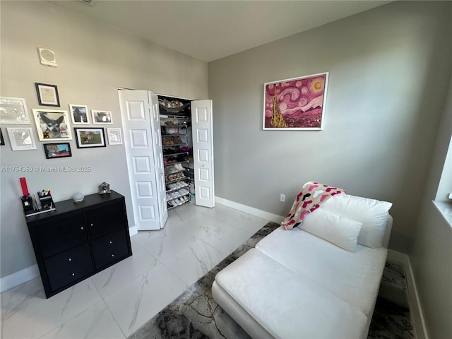 interior space with marble finish floor and baseboards