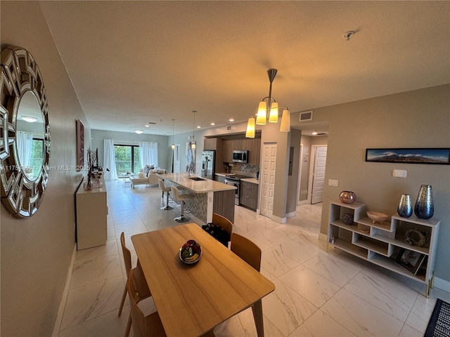 dining room with recessed lighting, marble finish floor, visible vents, and baseboards