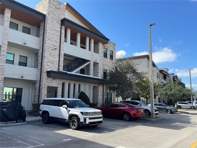 view of building exterior with uncovered parking