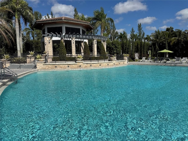 pool featuring a patio area and fence