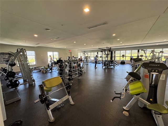 workout area with a wealth of natural light, visible vents, and recessed lighting