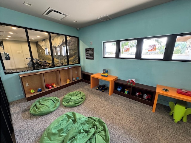 recreation room with carpet and visible vents