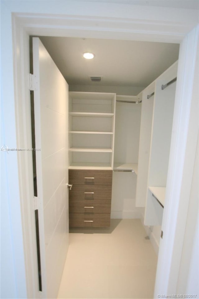 spacious closet featuring visible vents