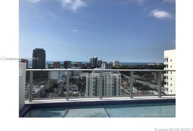 view of swimming pool with a view of city