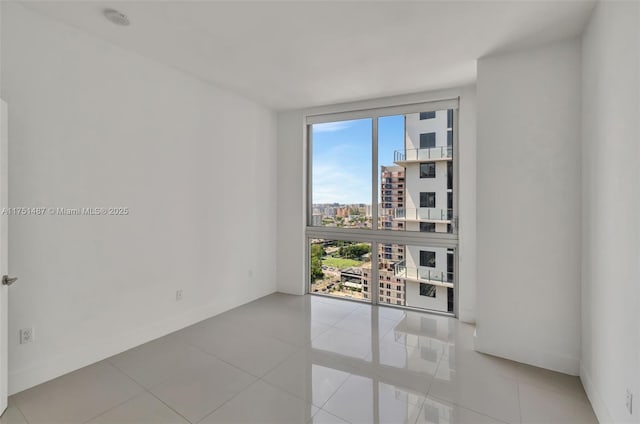 1010 SW 2nd Ave Unit Lph05, Miami, FL 33130 - unfurnished room featuring a view of city, tile patterned floors, and a smoke detector