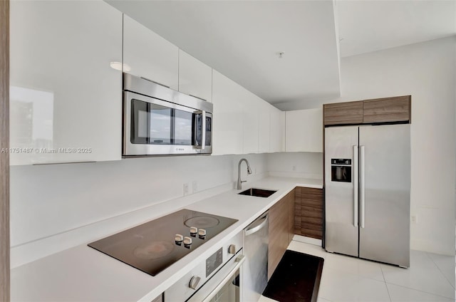 1010 SW 2nd Ave Unit Lph05, Miami, FL 33130 - kitchen featuring appliances with stainless steel finishes, a sink, light countertops, and light tile patterned flooring