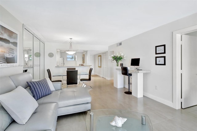 living area with visible vents and baseboards