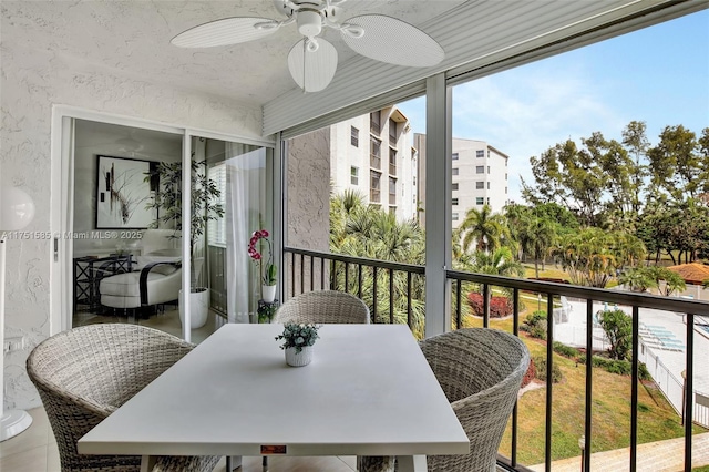 balcony with a ceiling fan and outdoor dining space