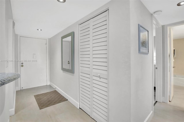 corridor featuring recessed lighting and baseboards