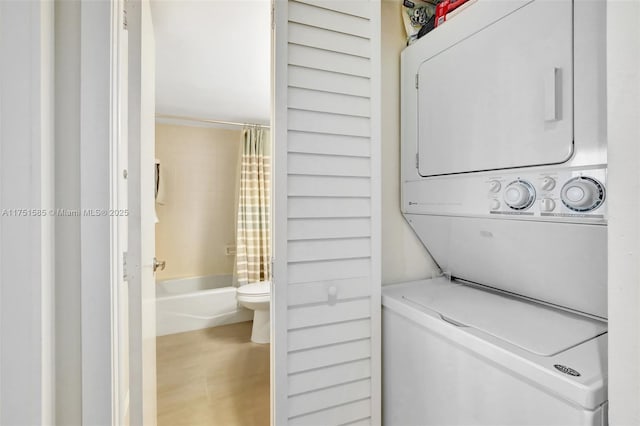 washroom featuring laundry area and stacked washer and clothes dryer