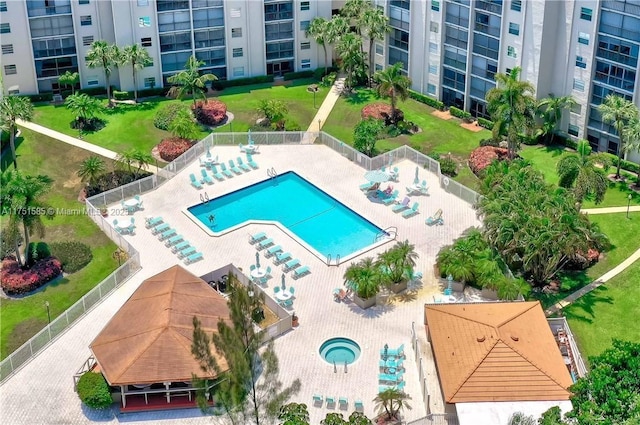 pool with a patio area and fence