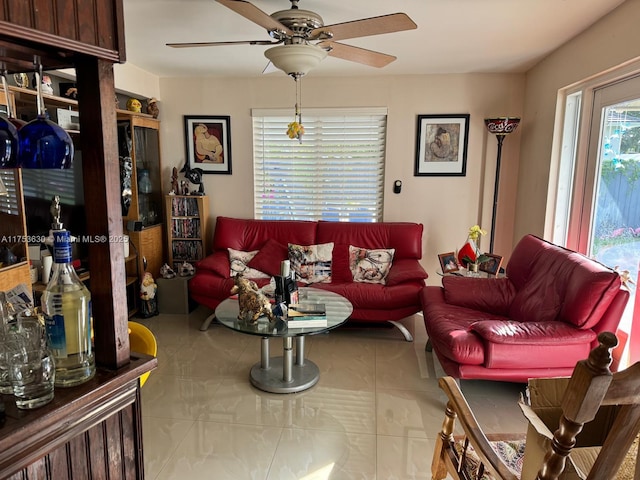 tiled living area with a ceiling fan