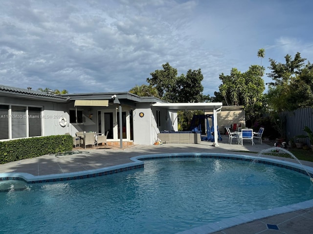 view of pool featuring outdoor dining space, fence, a fenced in pool, and a patio