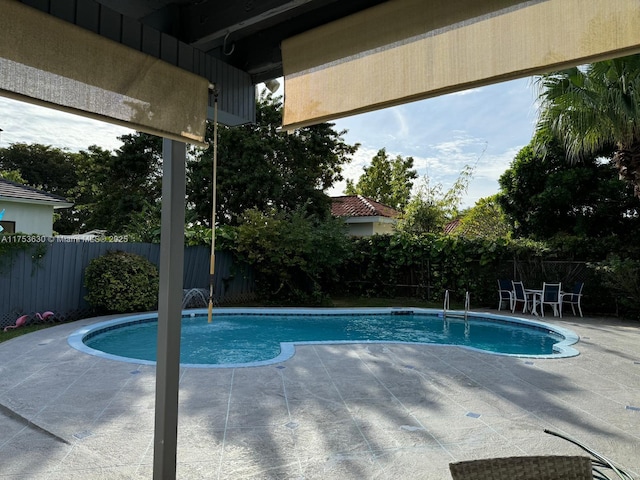 view of swimming pool featuring a patio, a fenced backyard, and a fenced in pool