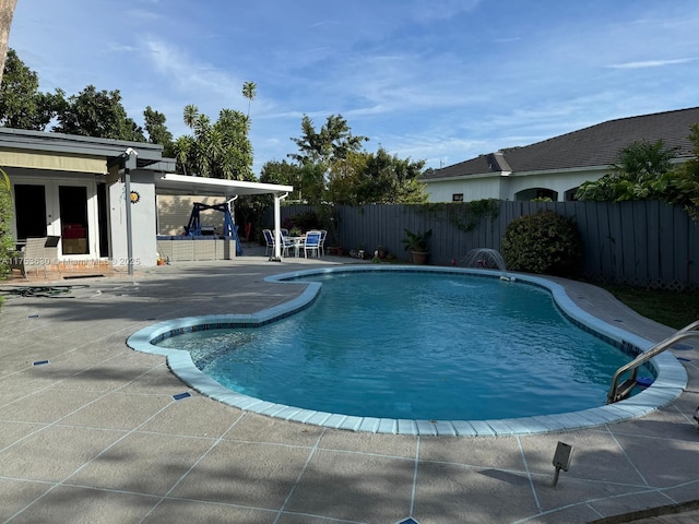 view of swimming pool featuring a patio area, a fenced backyard, and a fenced in pool