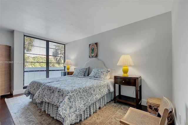 bedroom with wood finished floors and baseboards