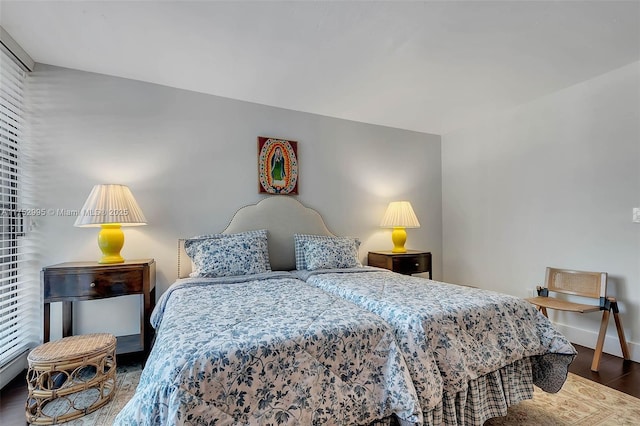 bedroom featuring wood finished floors and baseboards