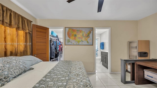 bedroom with connected bathroom, ceiling fan, a spacious closet, a closet, and light tile patterned flooring