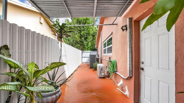 exterior space with ac unit, a fenced backyard, cooling unit, and stucco siding