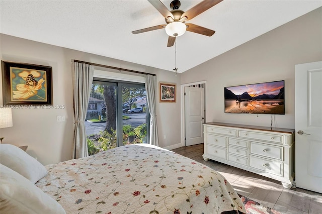 bedroom featuring a ceiling fan, vaulted ceiling, wood finished floors, access to outside, and baseboards