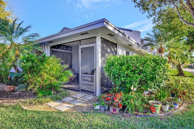 view of outdoor structure featuring a sunroom