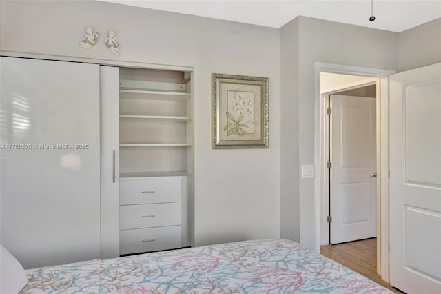 bedroom featuring a closet and wood finished floors