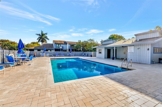 pool featuring a patio area and fence