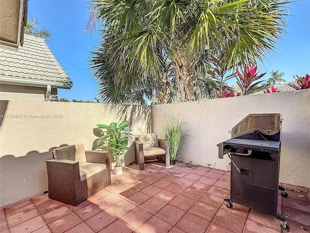 view of patio / terrace featuring area for grilling and a fenced backyard