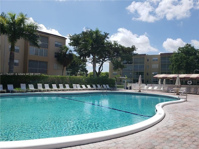 pool with fence and a patio