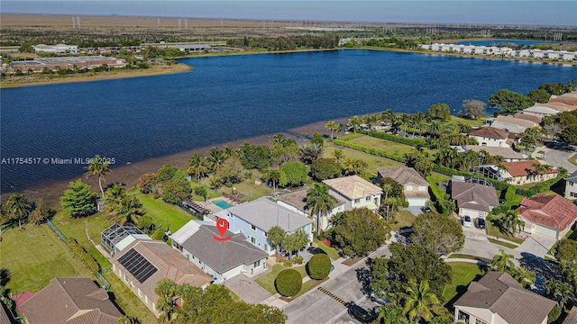 bird's eye view with a water view and a residential view