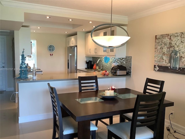 dining space with ornamental molding and recessed lighting