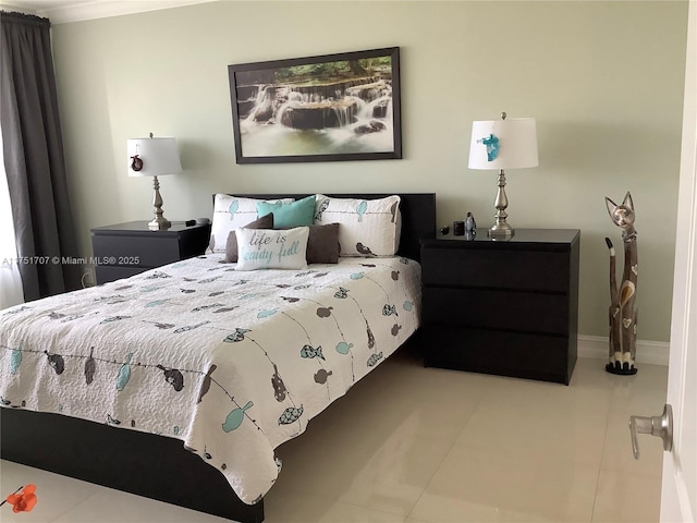 tiled bedroom featuring baseboards