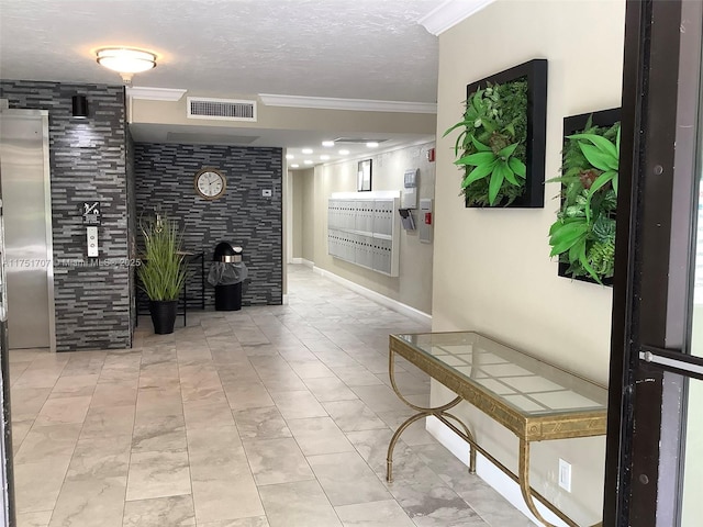 corridor featuring a textured ceiling, mail area, visible vents, and crown molding