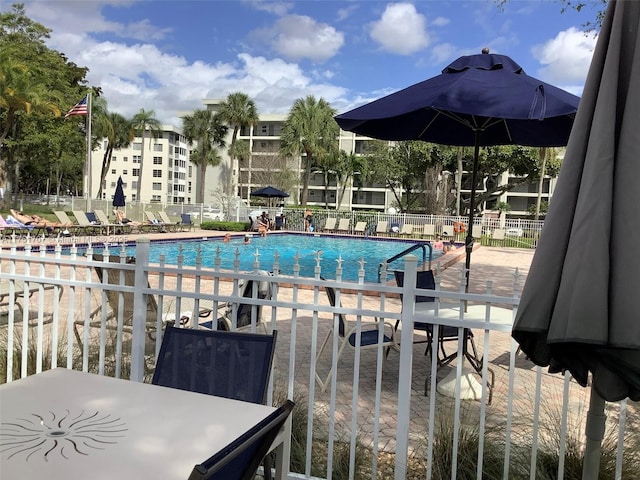 pool featuring a patio and fence