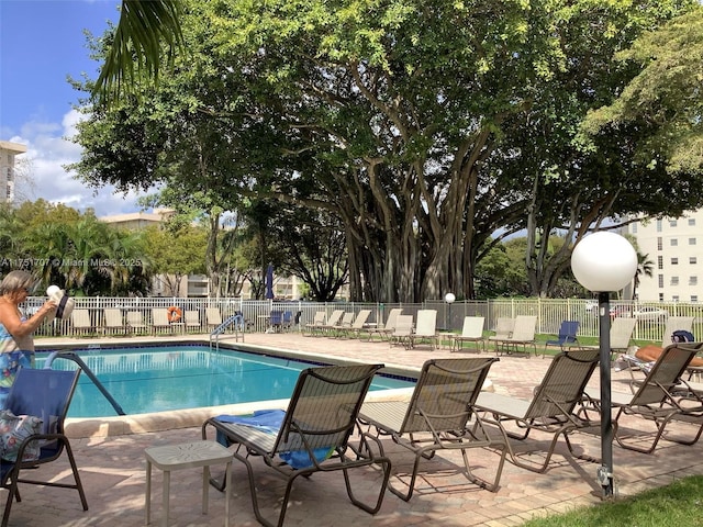 pool featuring a patio area and fence