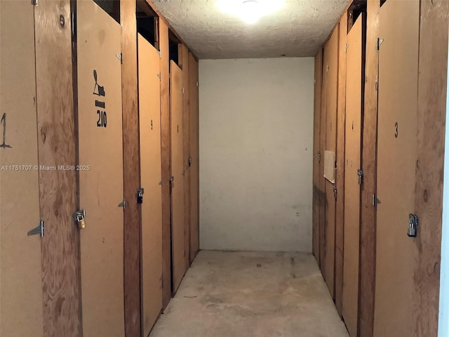 hall featuring unfinished concrete flooring