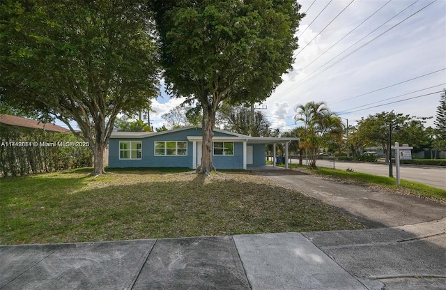 view of front of home featuring a carport, a front yard, fence, and driveway